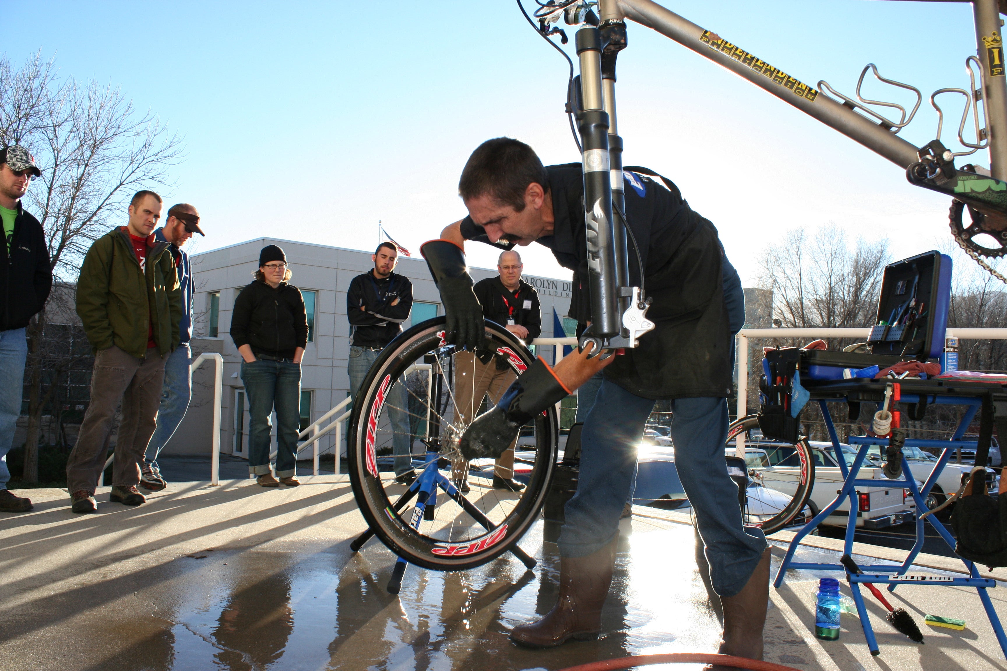 Calvin Jones checks the bearings of a wheel he has just washed. Photo: Caley Fretz © VeloNews