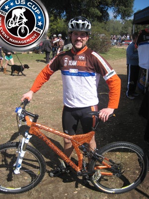 Team Duke member Michael Page with a bike that was decorated by child cancer patients and jersey that was hand decorated by Cooper, a child cancer patient. Courtesy Photo