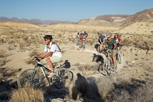 President George W. Bush on the front aboard his Trek Superfly 100. Bush is leading 14 veterans wounded in Iraq or Afghanistan in the Big Bend Ranch State Park of Texas during the first day of the W100K mountain bike ride. Photo by Paul Morse.
