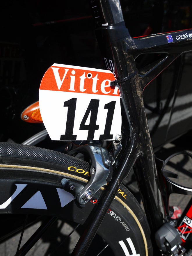 The team leader usually gets the first number in the team's allotment. BMC Racing has some cool carbon fiber number hangers but mechanics zip tie them to the seat tube to keep them from dropping down onto the tire.