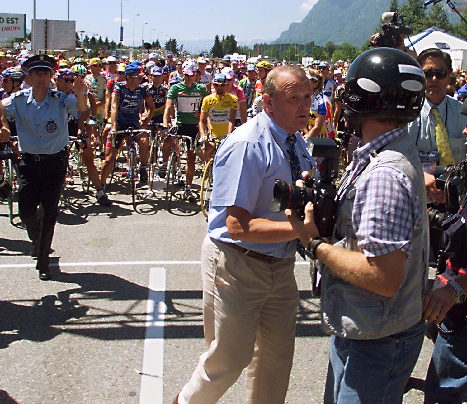 Race director Jean-Marie Leblanc pushes photographers before stage 17 of the 1998 Tour de France as riders prepare a protest over a doping inquiry. Photo: AFP