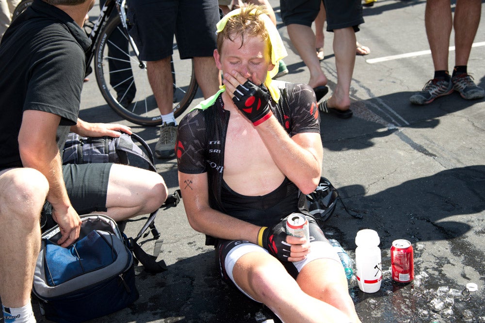 Lawson Craddock sits in a puddle of melting ice as he recovers from riding up the finishing climb in searing temperatures after stage 2 of the Amgen Tour of California. Photo: Casey B. Gibson | <a href="http://www.cbgphoto.com">www.cbgphoto.com</a>