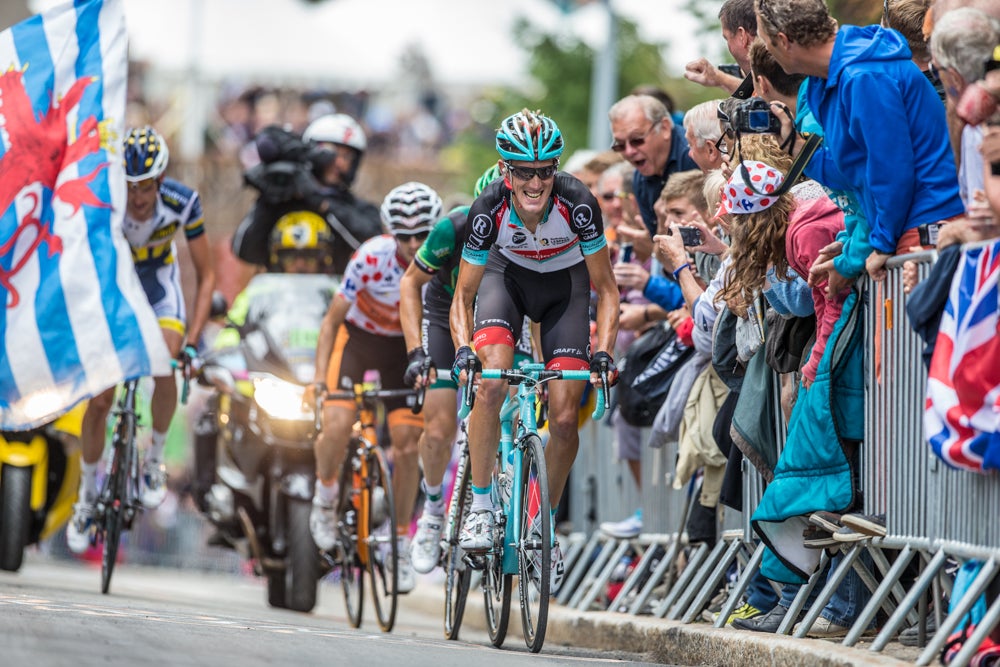 With the Luxembourg flag flying proudly, Andy Schleck attacks from the peloton on stage 18 of the 2013 Tour with Pierre Rolland, Mikel Nieve, and Wouter Poels. Photo: BrakeThrough Media | VeloNews.com