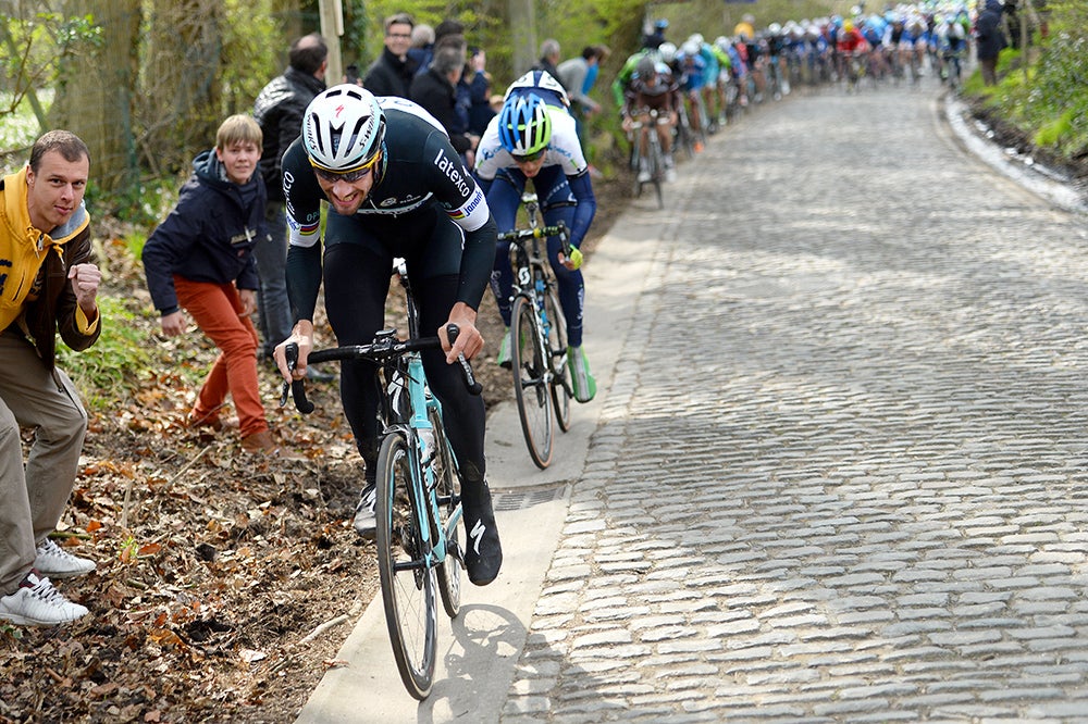 Tom Boonen stretches his (legwarmer-covered) legs at the 2014 Dwars door Vlaanderen, on the Taaienberg, his favorite climb. Photo: Tim De Waele | <a href="http://www.tdwsport.com" target="_blank">TDWsport.com</a>