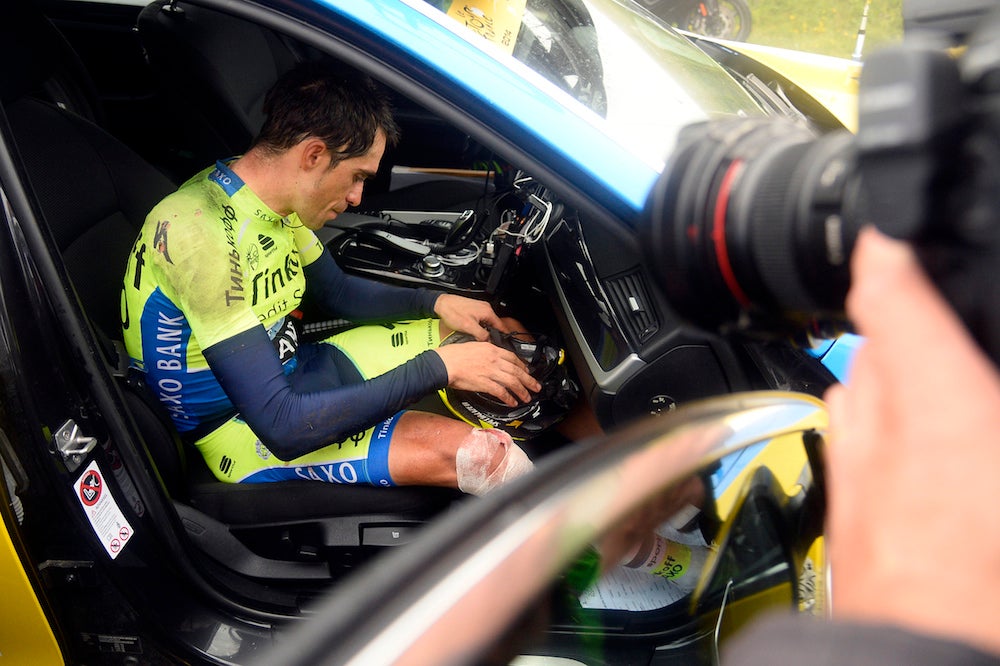 Alberto Contador climbed into the team car and abandoned the Tour after injuring his right knee in a crash during stage 10. Photo: AFP