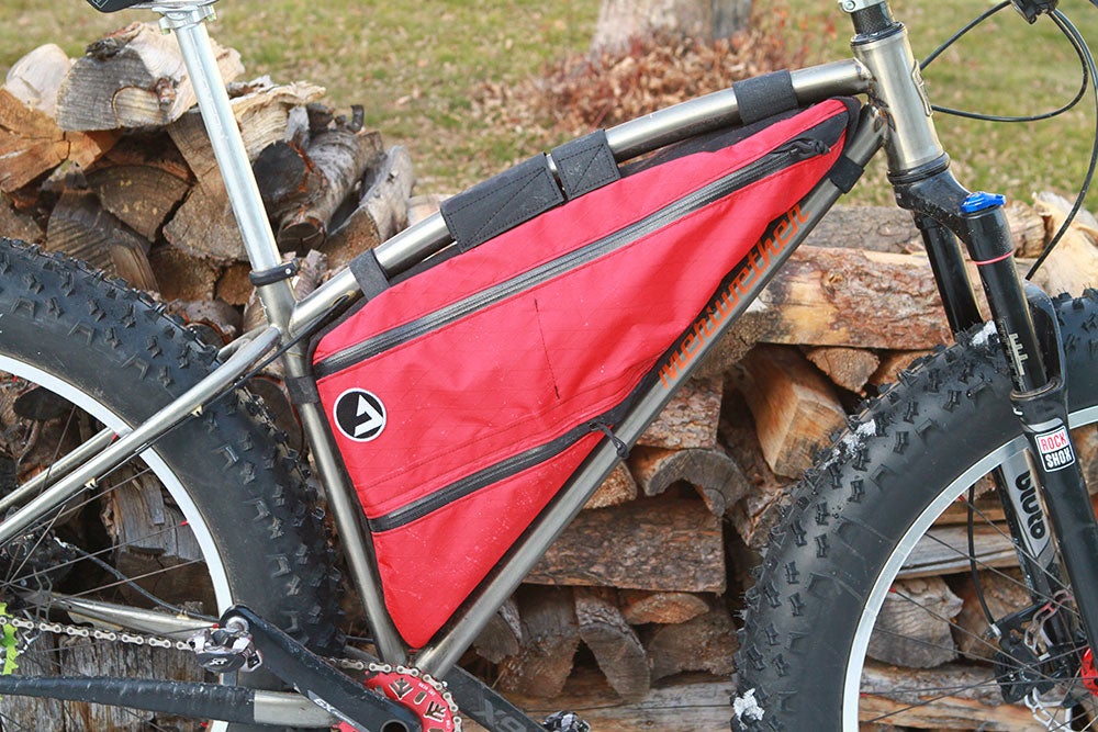 It secures to the top tube via Velcro straps and to the seat and down tubes via water bottle cage bosses. Photo: Dan Cavallari | VeloNews