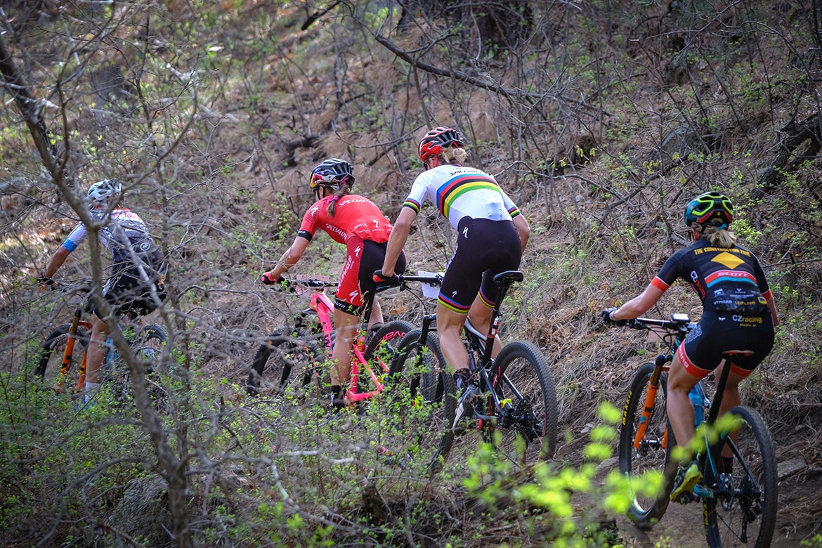 The lead group of women was down to the four expected favorites shortly after they entered the singletrack portion of the course. Photo: Dave McElwaine