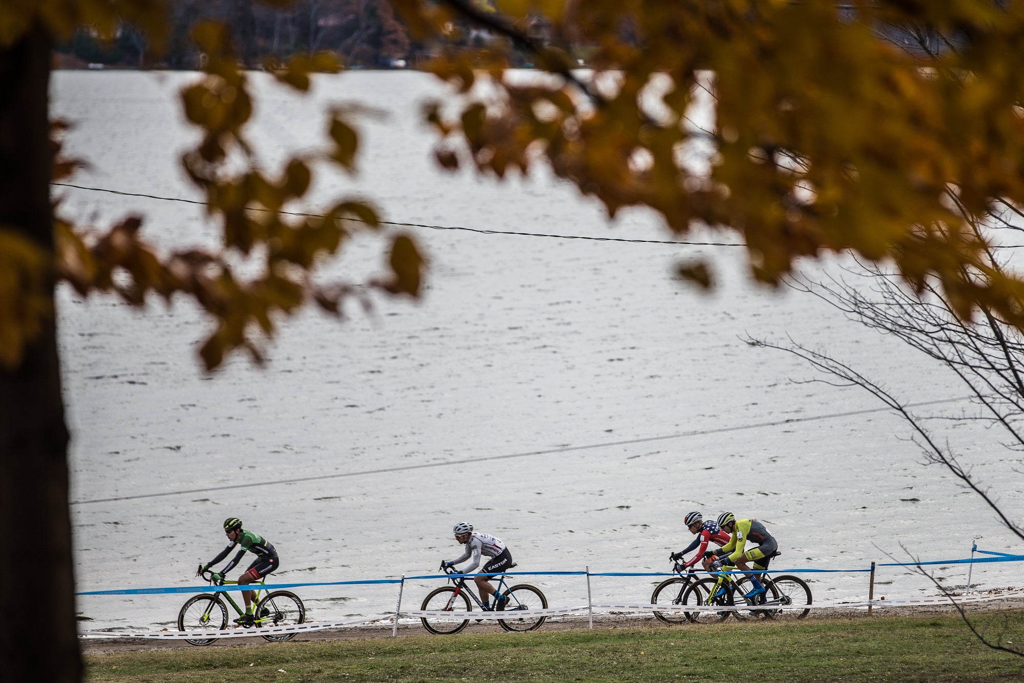 The lead four riders of the elite men's field hit the first of two beach sections along the northern edge of Little Lake, just off Lake Huron's Georgian Bay. Prevailing winds traveled across the water, bringing cold temperatures onto the venue. Photo: Wil Matthews