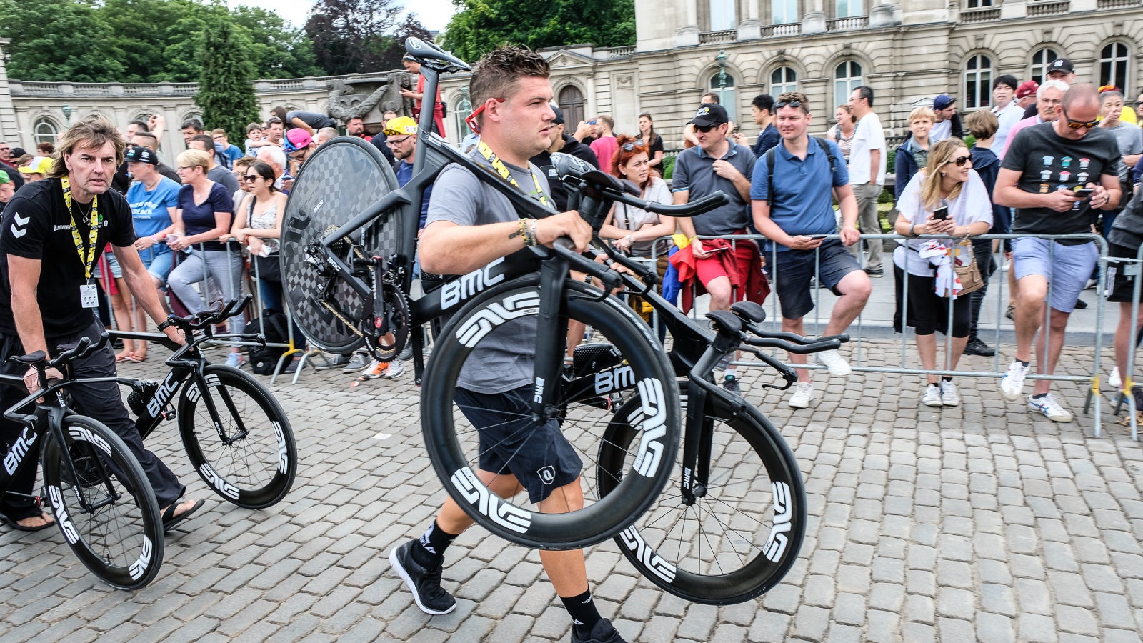 Clean and new equals fast. A team mechanic carries bikes to check-in rather than rolling them on the ground. Perhaps an idealistic precaution, but if nothing else, the bikes will look pristine at the starting line.  Photo: Dan Cavallari | VeloNews.com