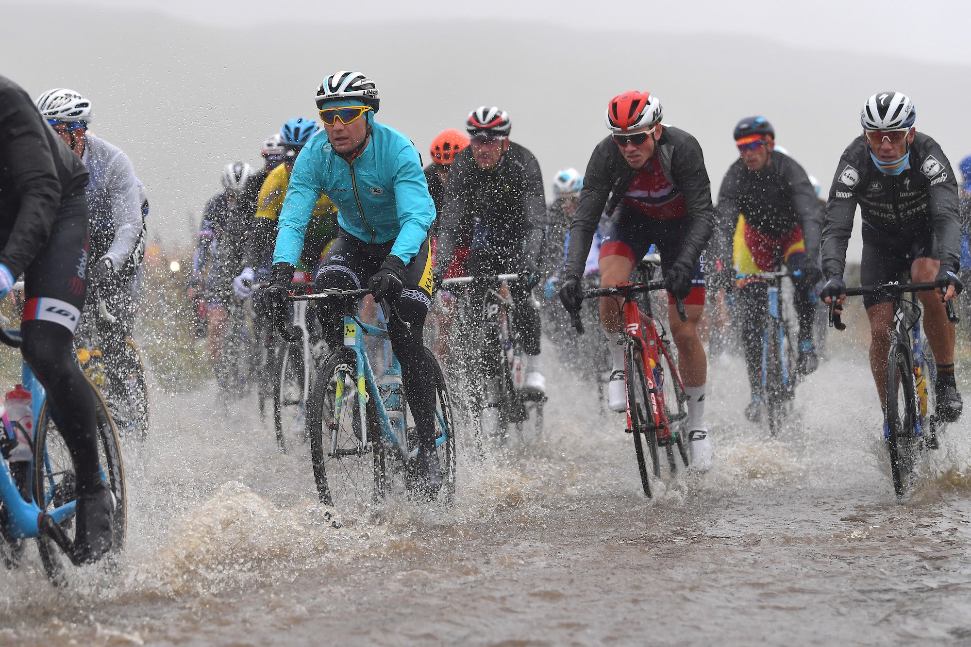 The first 150km of the race saw the peloton battle pelting rain, cool temperatures, and deep puddles. Photo: Justin Setterfield/Getty Images