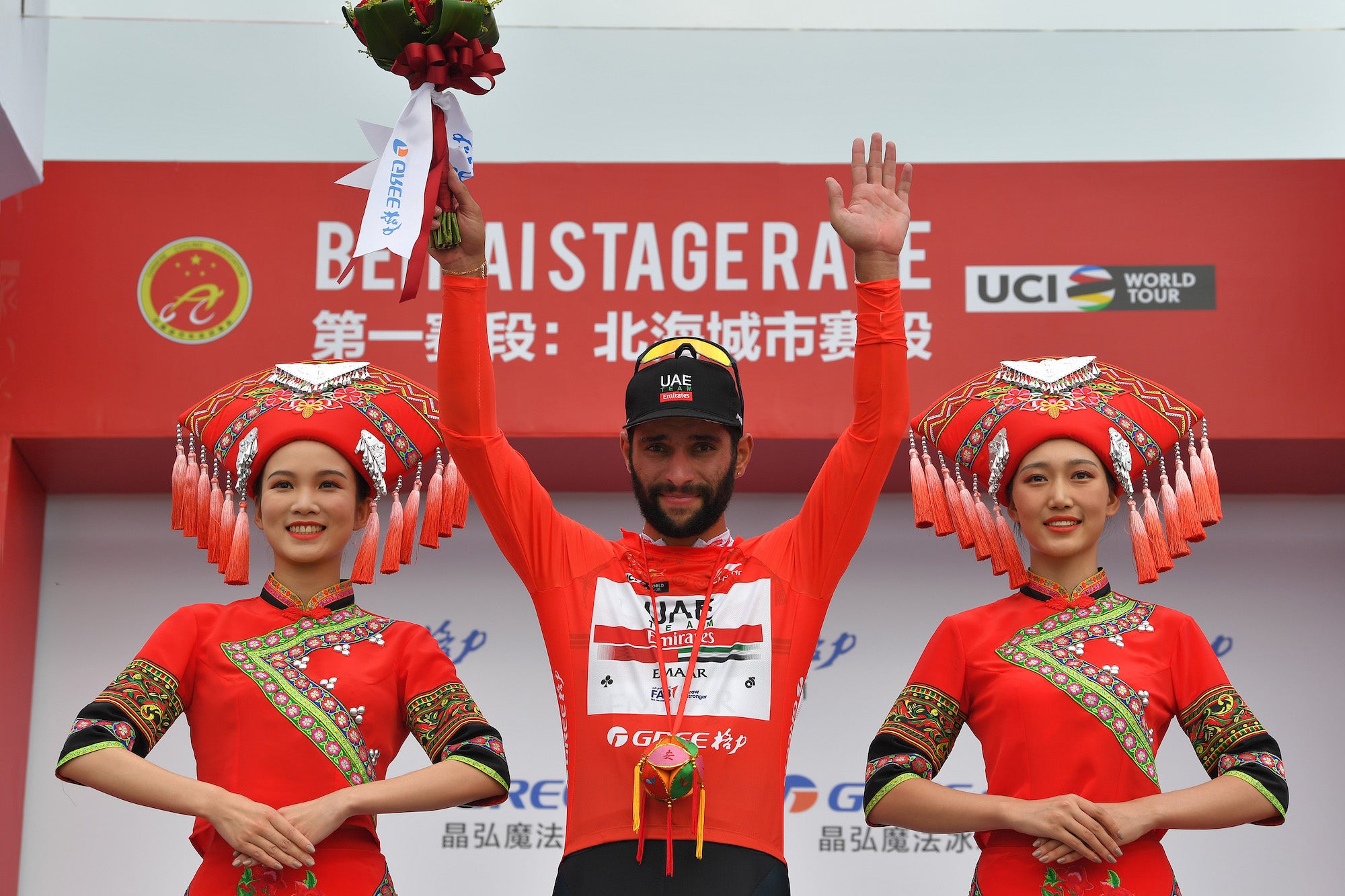 BEIHAI, CHINA - OCTOBER 17: Podium / Fernando Gaviria of Colombia and UAE - Team Emirates Red Leader Jersey / Celebration / Miss / Hostess / during the 3rd Tour Of Guangxi 2019, Stage 1 a 135,6km stage from Beihai to Beihai / @TourofGuangxi / on October 17, 2019 in Beihai, China.