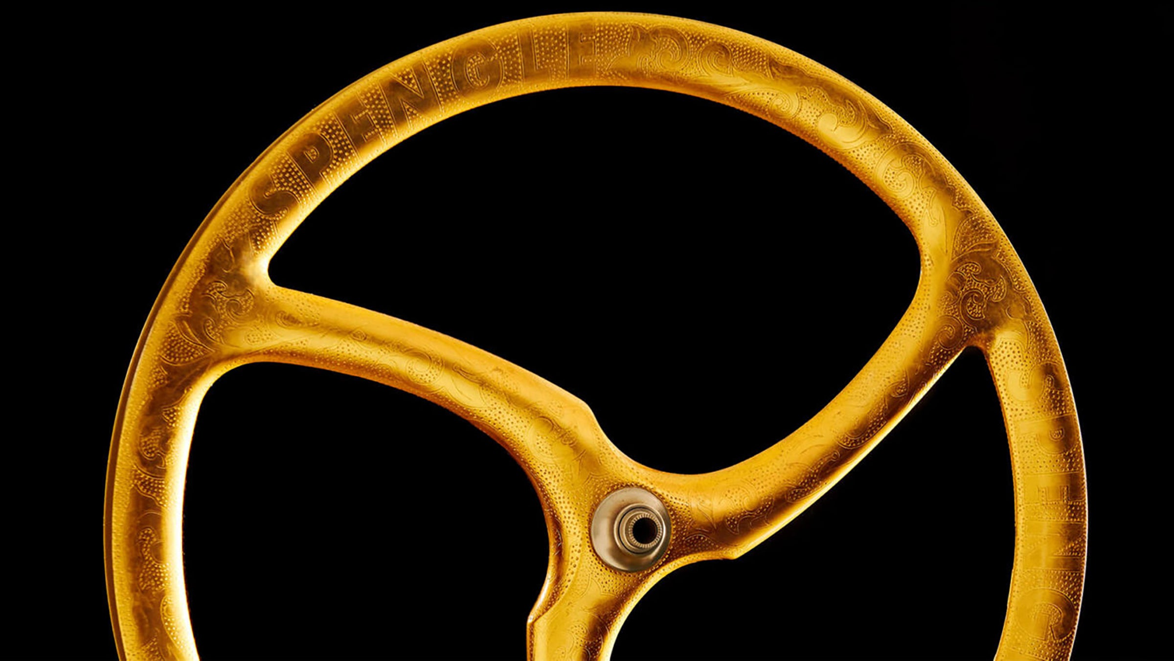 Spengle gold and carbon monocoque tri-spoke wheel