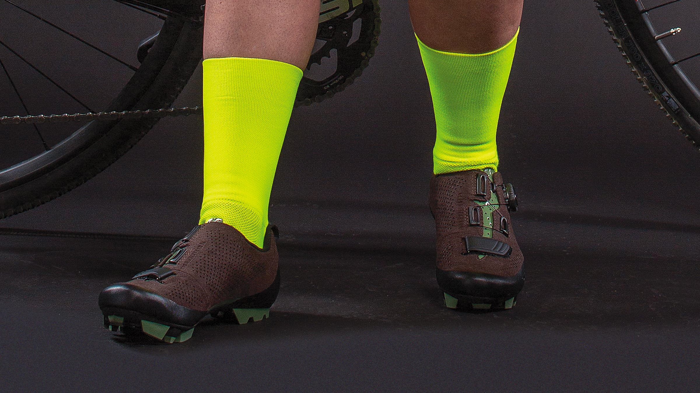 Detail of woman's cycling socks and gravel shoes