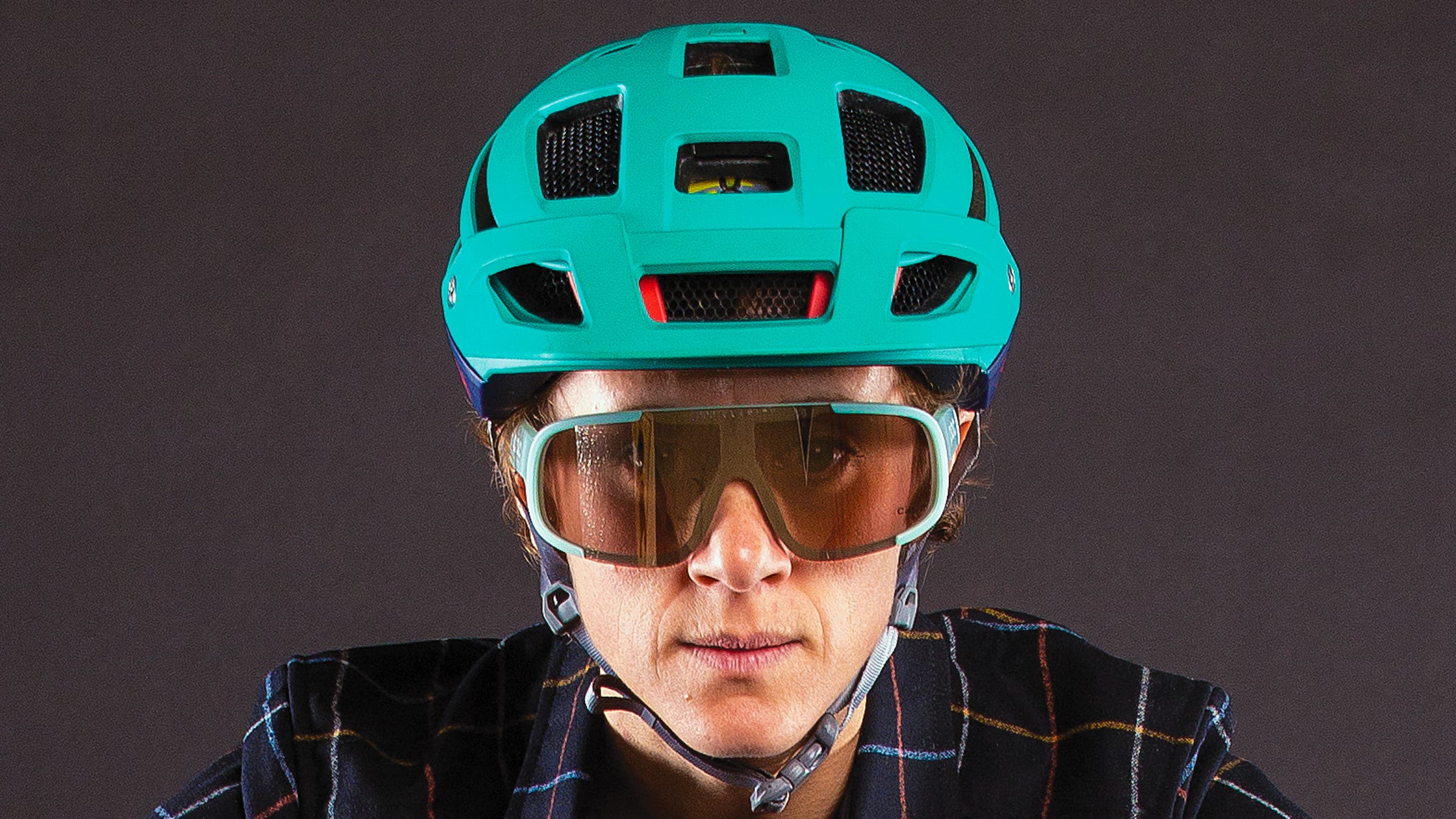 Close-up of woman wearing cycling helmet and sunglasses