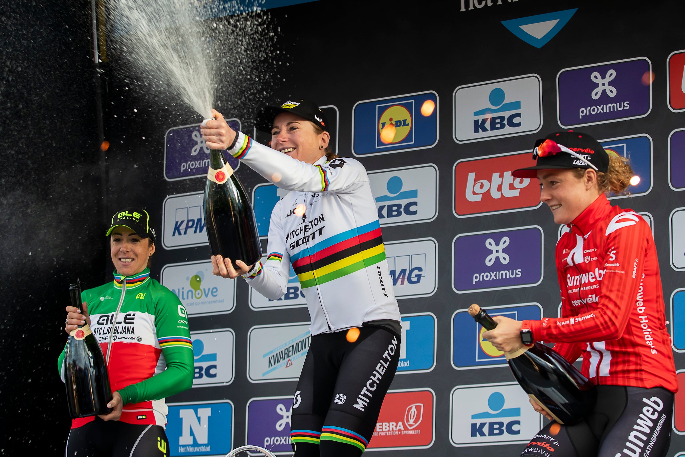 (LtoR) Second placed Italian cyclist Marta Bastianelli, winner Dutch cyclist Annemiek van Vleuten and third place Dutch cyclist Floortje Mackaij spray champagne as they celebrate on the podium after the Women's Elite race of the 75th edition of the one-day cycling race 'Omloop Het Nieuwsblad', 126,1km from Merelbeke to Ninove, on February 29, 2020 Ninove. (Photo by KRISTOF VAN ACCOM / BELGA / AFP) / Belgium OUT (Photo by KRISTOF VAN ACCOM/BELGA/AFP via Getty Images)