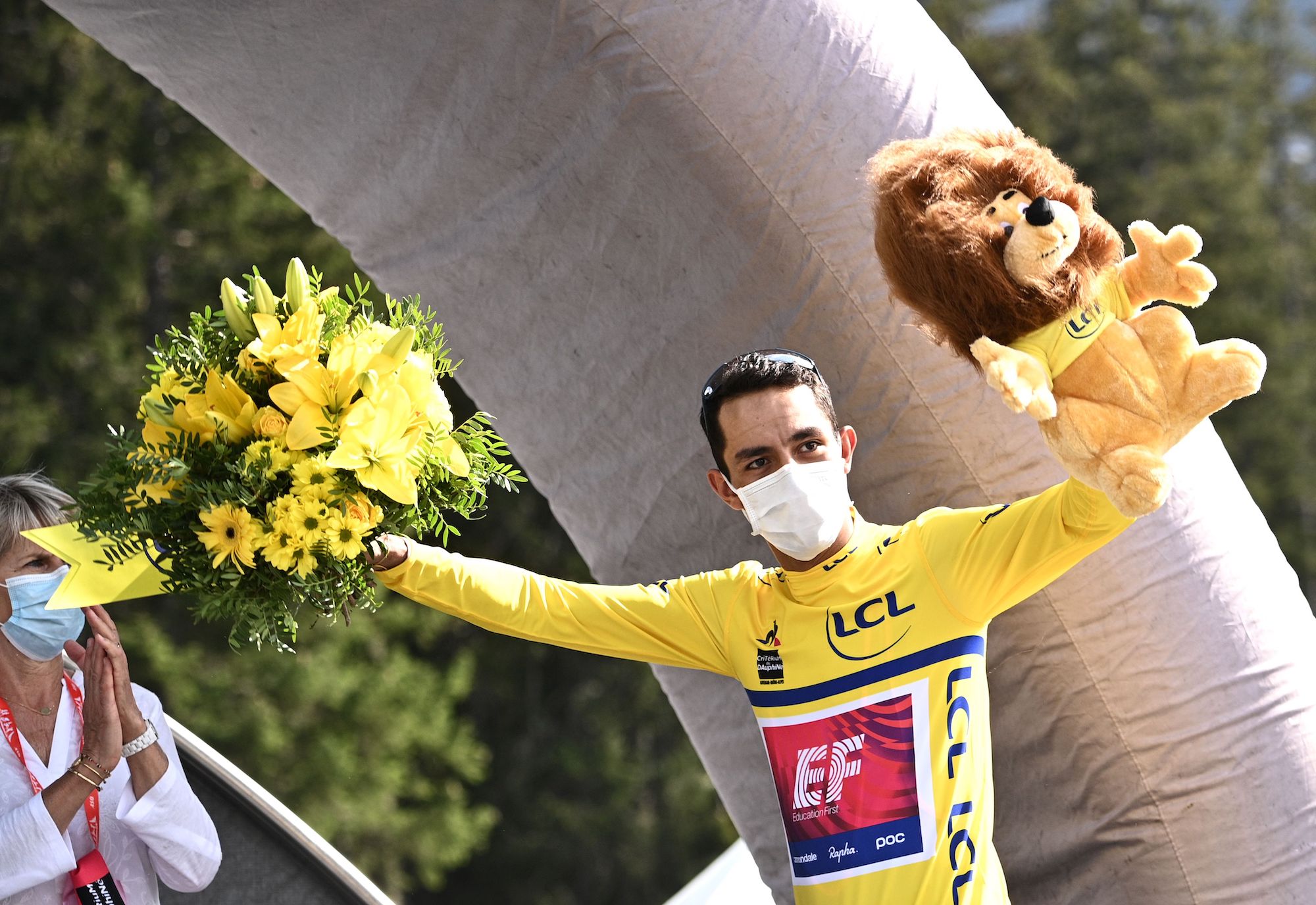 Team Education First rider Colombia's Daniel Martinez celebrates his overall leader's yellow jersey on the podium at the end of the fifth stage of the 72nd edition of the Criterium du Dauphine cycling race, 153 km between Megeve and Megeve on August 16, 2020. (Photo by Anne-Christine POUJOULAT / POOL / AFP) (Photo by ANNE-CHRISTINE POUJOULAT/POOL/AFP via Getty Images)