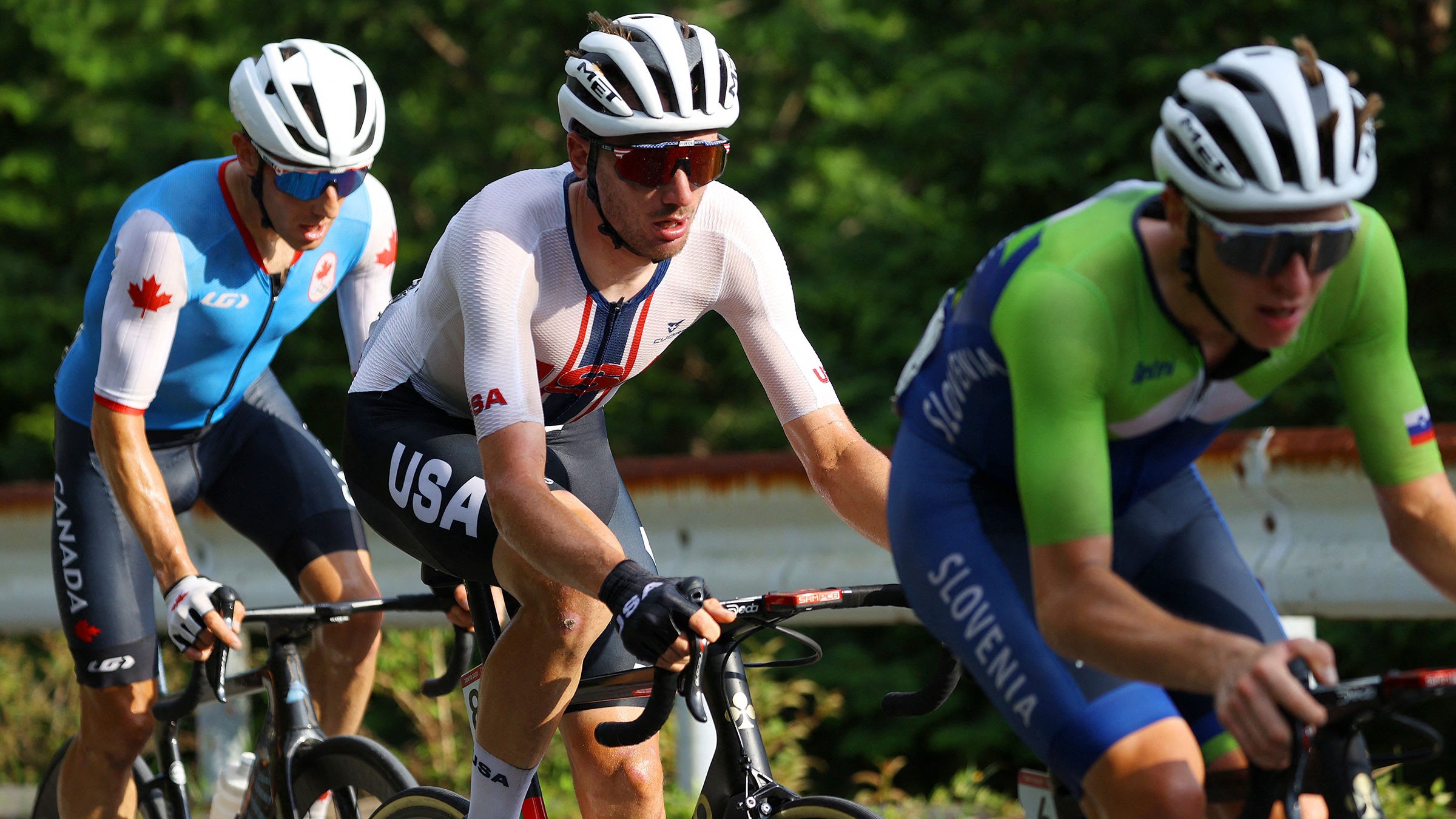 Michael Woods, Brandon McNulty, and Tadej Pogacar at the 2020 Tokyo Olympic Games road cycling race.