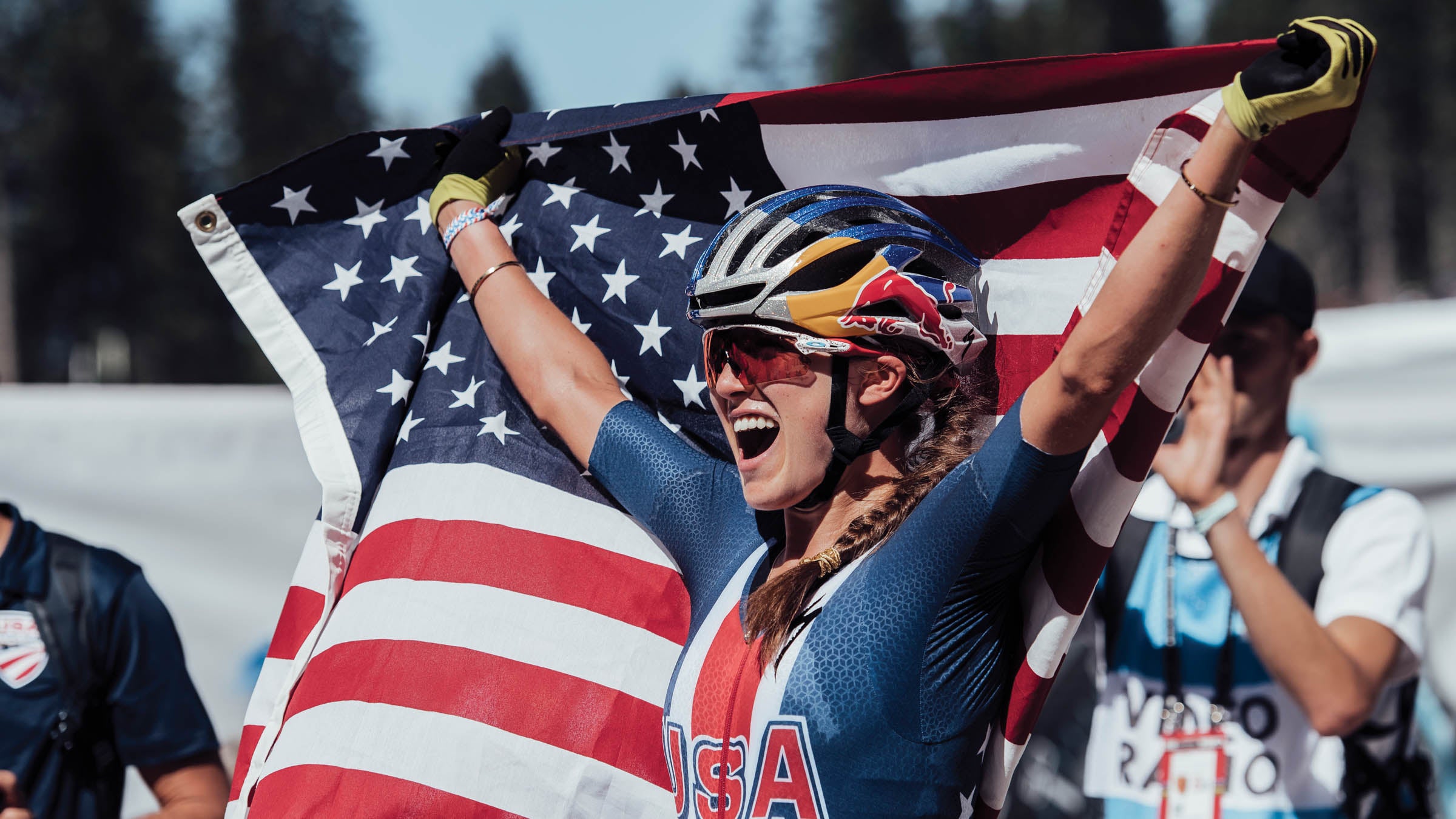 Kate Courtney holding an American flag