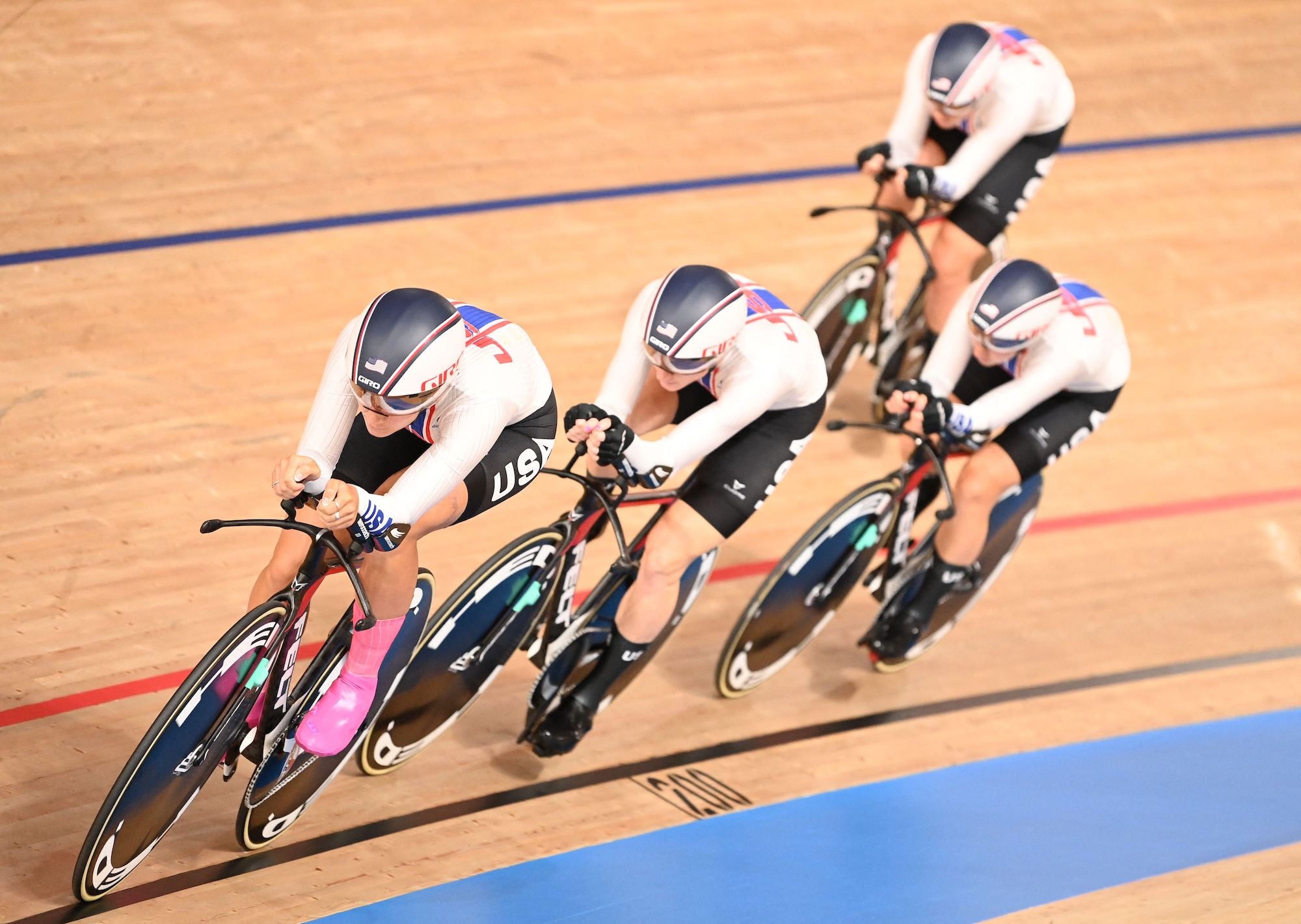 USA's Jennifer Valente, USA's Chloe Dygert, USA's Emma White and USA's Lily Williams compete in the women's track cycling team pursuit qualifying event during the Tokyo 2020 Olympic Games at Izu Velodrome in Izu, Japan, on August 2, 2021. (Photo by Peter PARKS / AFP) (Photo by PETER PARKS/AFP via Getty Images)
