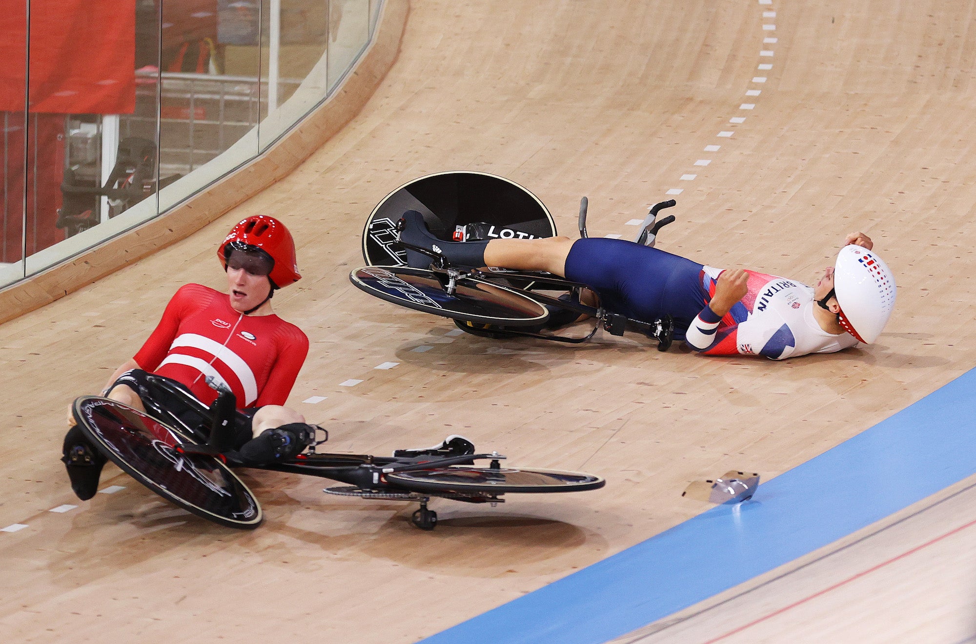IZU, JAPAN - AUGUST 03: (L-R) Frederik Madsen of Team Denmark and Charlie Tanfield of Team Great Britain on the ground after fall during the Men´s team pursuit first round, heat 4 of the Track Cycling on day eleven of the Tokyo 2020 Olympic Games at Izu Velodrome on August 03, 2021 in Izu, Japan. (Photo by Justin Setterfield/Getty Images)