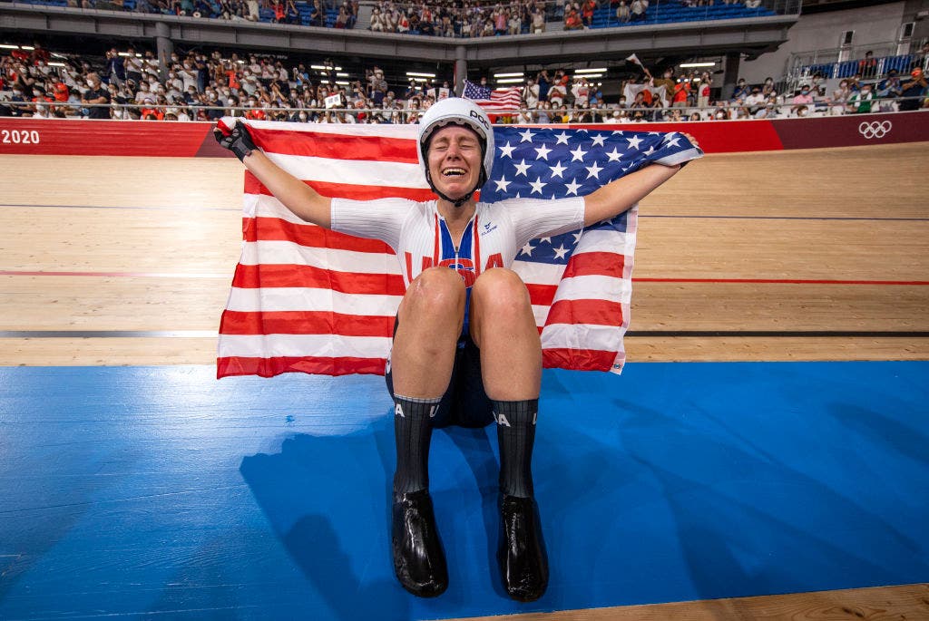 IZU, JAPAN - AUGUST 08: Jennifer Valente of Team United States celebrates winning the gold medal while holding the flag of her country during the Women's Omnium points race, 4 round of 4 of the track cycling on day sixteen of the Tokyo 2020 Olympic Games at Izu Velodrome on August 08, 2021 in Izu, Shizuoka, Japan. (Photo by Justin Setterfield/Getty Images)