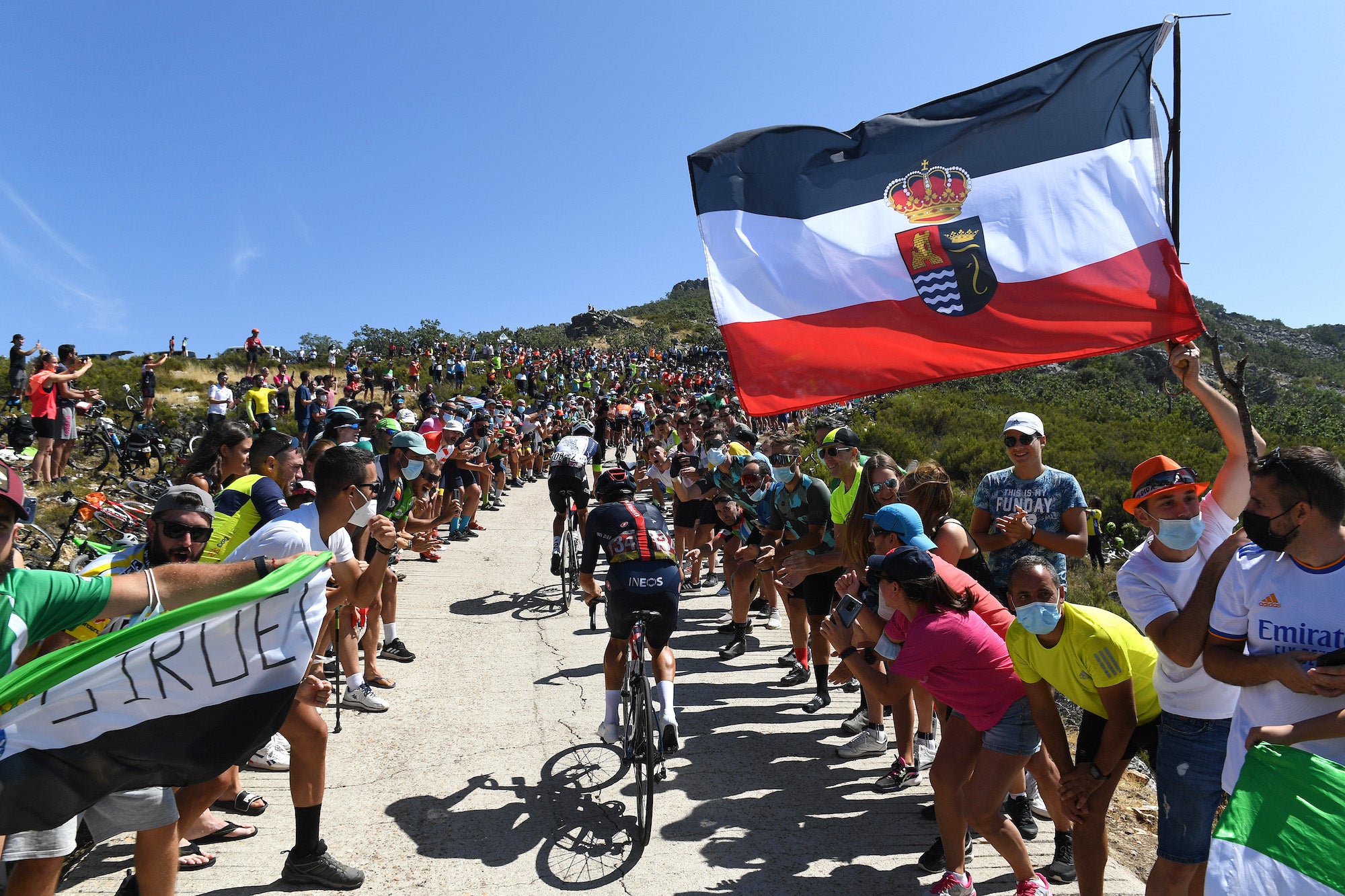 PICO VILLUERCAS, SPAIN - AUGUST 28: A general view of Thomas Pidcock of United Kingdom and Team INEOS Grenadiers and Dylan Sunderland of Australia and Team Qhubeka Nexthash beginning to climb the Alto Collado de Ballesteros (1415m) while fans cheer during the 76th Tour of Spain 2021, Stage 14 a 165,7km stage from Don Benito to Pico Villuercas 1580m / @lavuelta / #LaVuelta21 / on August 28, 2021 in Pico Villuercas, Spain. (Photo by Tim de Waele/Getty Images)