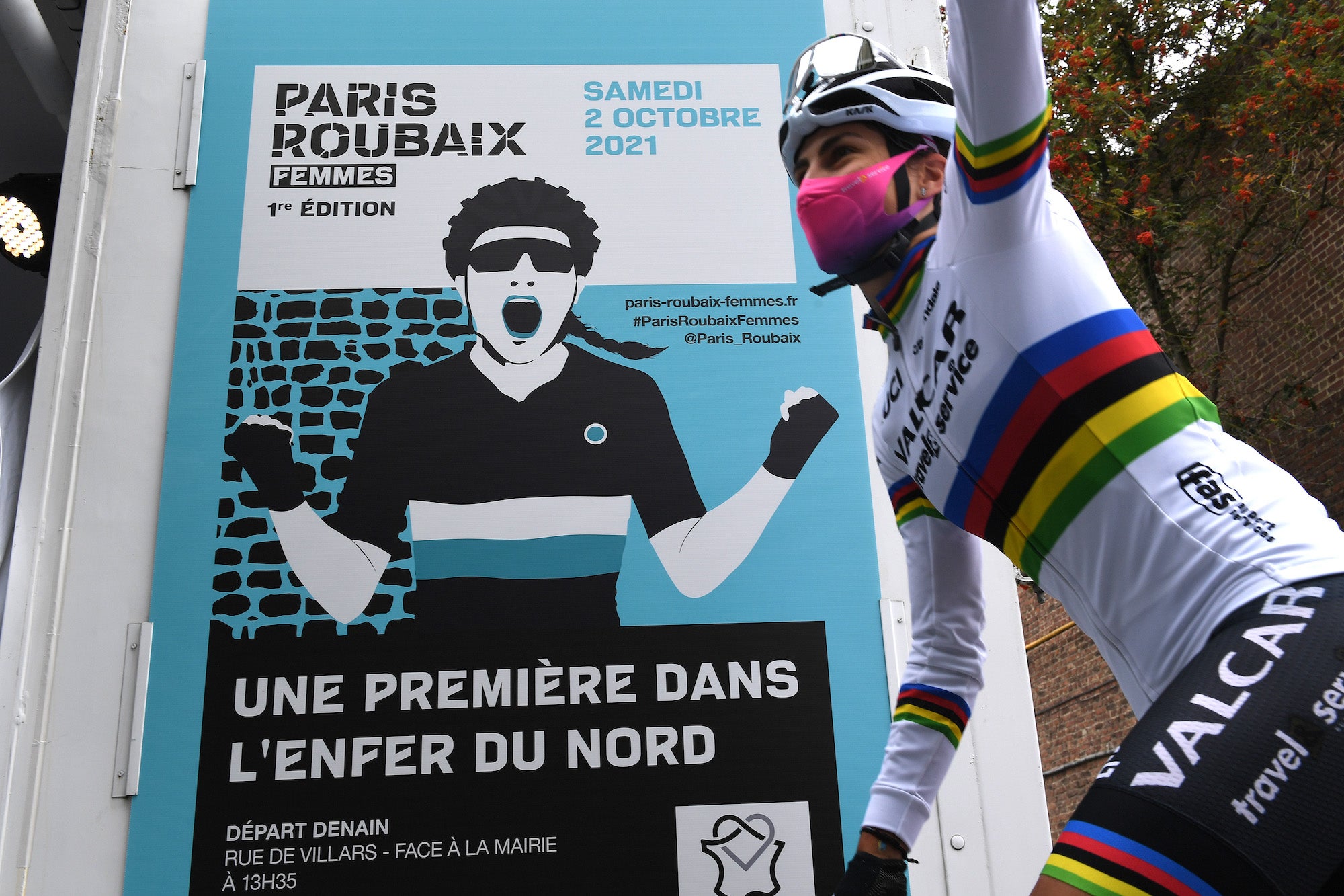 ROUBAIX, FRANCE - OCTOBER 02: Detailed view of a poster announcing the race while Elisa Balsamo of Italy and Team Valcar - Travel &amp; Service world champion rainbow jersey waves to the crowd in the 1st Paris-Roubaix 2021 - Women's Elite a 116,4km race from Denain to Roubaix / #ParisRoubaixFemmes / #ParisRoubaix / on October 02, 2021 in Roubaix, France. (Photo by Tim de Waele/Getty Images)