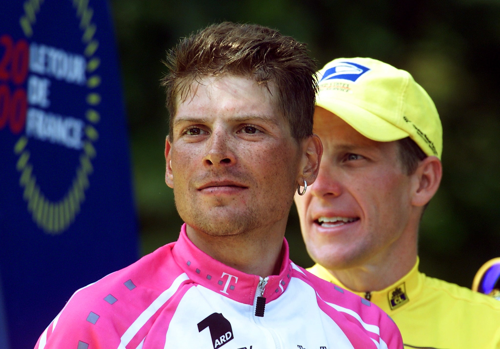 PARIS, FRANCE: The 2000 Tour de France winner US Lance Armstrong (R) stands on the podium with the second, the 1997 Tour de France winner German Jan Ullrich (L) on the 'Champs Elysees' after the last stage of the French cycling race in Paris 23 July 2000. AFP PHOTO JOEL SAGET (Photo credit should read JOEL SAGET/AFP via Getty Images)