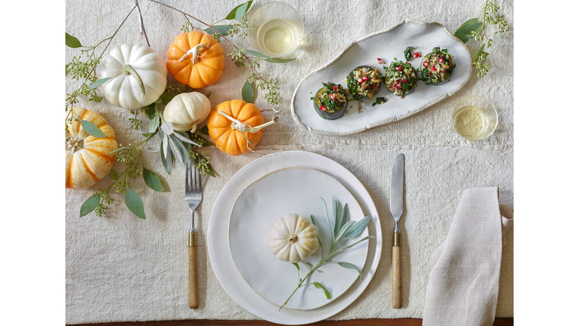 Table setting with decorative pumpkins and hors d'oeuvres