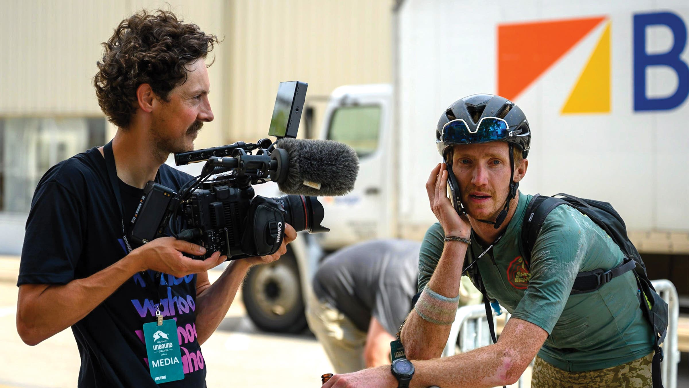 Boswell talks on his phone while a cameraman films him