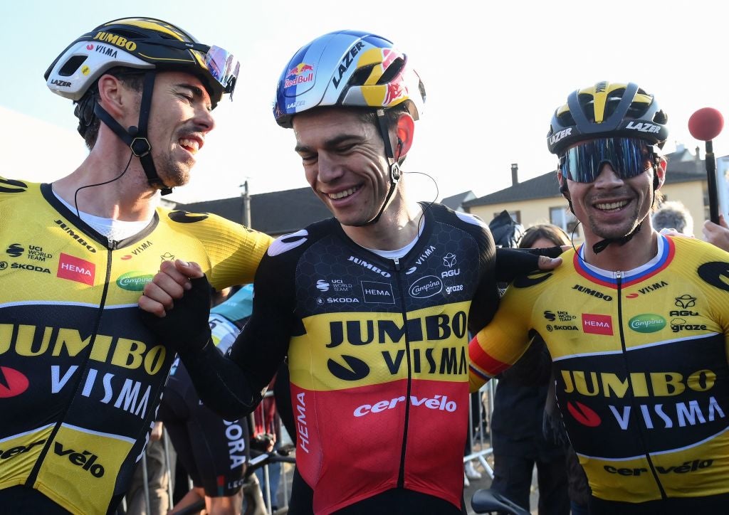 Jumbo-Visma's French rider Christophe Laporte (L), Jumbo-Visma's Belgian rider Wout Van Aert (C) and Jumbo-Visma's Slovenian rider Primoz Roglic (R) celebrate after crossing the finish line at the end of the 1st stage of the 80th Paris - Nice cycling race, 160 km between Mantes-la-Ville and Mantes-la-Ville, on March 6, 2022. (Photo by FRANCK FIFE / AFP) (Photo by FRANCK FIFE/AFP via Getty Images)