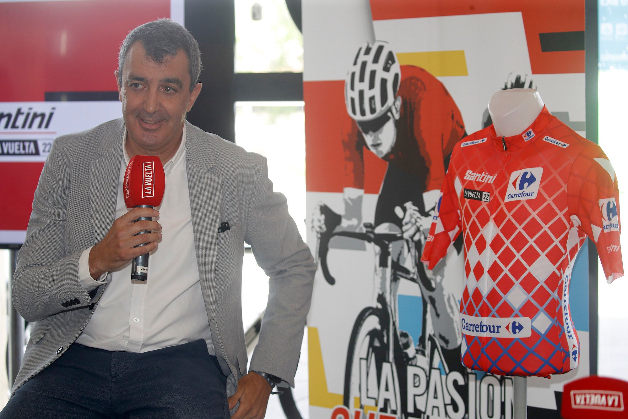 Vuelta director Javier Guillén poses with the special leader's jersey to be used in the opening stages.