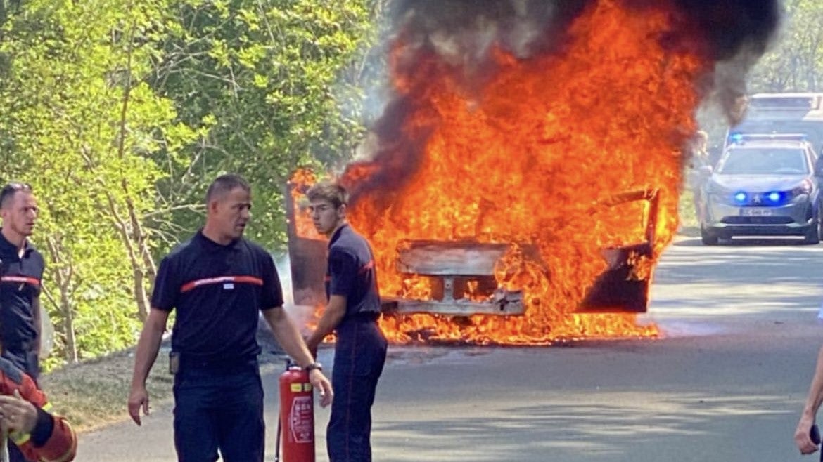 A police car on fire at the Tour de France