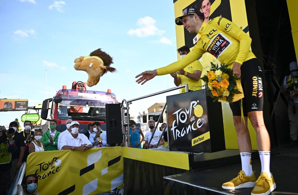 Jumbo-Visma team's Belgian rider Wout Van Aert celebrates with the overall leader's yellow jersey on the podium after the 2nd stage of the 109th edition of the Tour de France cycling race, 202,2 km between Roskilde and Nyborg, in Denmark, on July 2, 2022. (Photo by Anne-Christine POUJOULAT / AFP) (Photo by ANNE-CHRISTINE POUJOULAT/AFP via Getty Images)