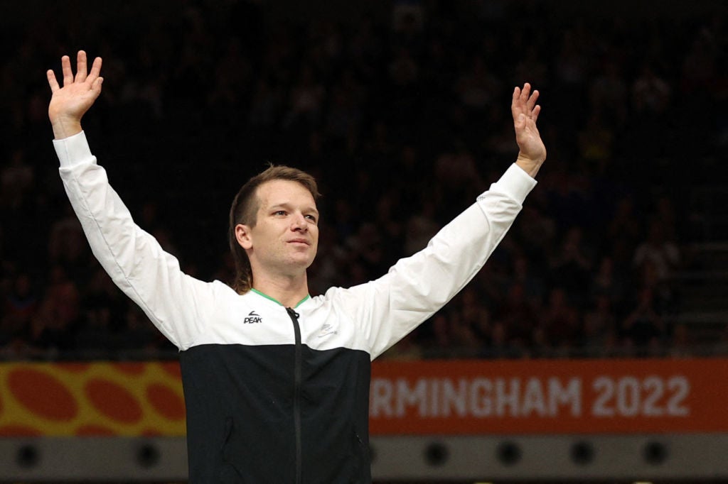 Gold medallist New Zealand's Aaron Gate celebrates on the podium during the medal presentation ceremony for the men's 4000m individual pursuit cycling event on day two of the Commonwealth Games, at the Lee Valley VeloPark in east London, on July 30, 2022. (Photo by ADRIAN DENNIS / AFP) (Photo by ADRIAN DENNIS/AFP via Getty Images)