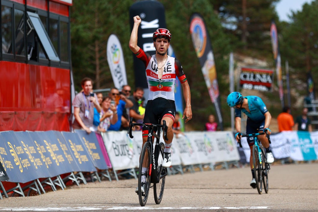 NEILA, SPAIN - AUGUST 06: Joao Almeida of Portugal and UAE Team Emirates celebrates winning ahead of Miguel Ángel López Moreno of Colombia and Team Astana – Qazaqstan during the 44th Vuelta a Burgos 2022, Stage 5 a 170km stage from Lerma to Lagunas de Neila 1867m / #VueltaBurgos / on August 06, 2022 in Neila, Spain. (Photo by Gonzalo Arroyo Moreno/Getty Images)