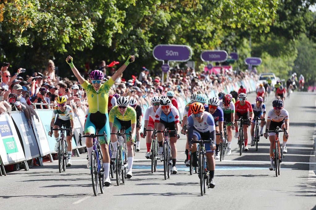 WARWICK, ENGLAND - AUGUST 07: Georgia Baker of Team Australia celebrates as they cross the line to win Gold in the Women's Road Race on day ten of the Birmingham 2022 Commonwealth Games at on August 07, 2022 on the Warwick, England. (Photo by Luke Walker/Getty Images)