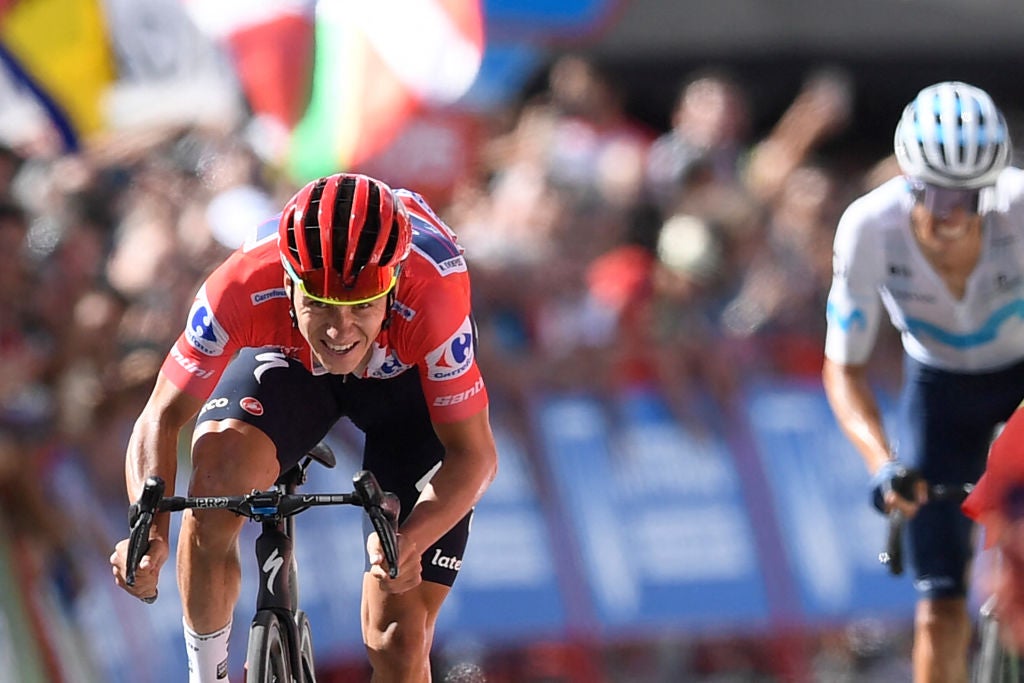 Team Quick Step's Belgian rider Remco Evenepoel (L) rides and crosses the finish line during the 18th stage of the 2022 La Vuelta cycling tour of Spain, a 192 km race from Trujillo to Alto del Piornal, on September 8, 2022. (Photo by OSCAR DEL POZO / AFP) (Photo by OSCAR DEL POZO/AFP via Getty Images)