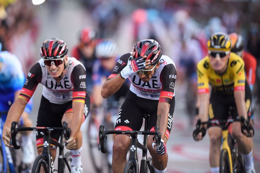 Team UAE Emirates' Columbian rider Sebastian Molano (C) celebrates after crossing the finish line in first place during the 21st and last stage of the 2022 La Vuelta cycling tour of Spain, a 96.7km race from Las Rozas de Madrid to Madrid, on September 11, 2022. - Belgian rider Remco Evenepoel claimed his first Grand Tour victory in the Vuelta a Espana in Madrid. The 22-year-old dominated the three-week race, taking victory after the 21st and final stage won by Colombian Juan Sebastian Molano. (Photo by OSCAR DEL POZO / AFP) (Photo by OSCAR DEL POZO/AFP via Getty Images)