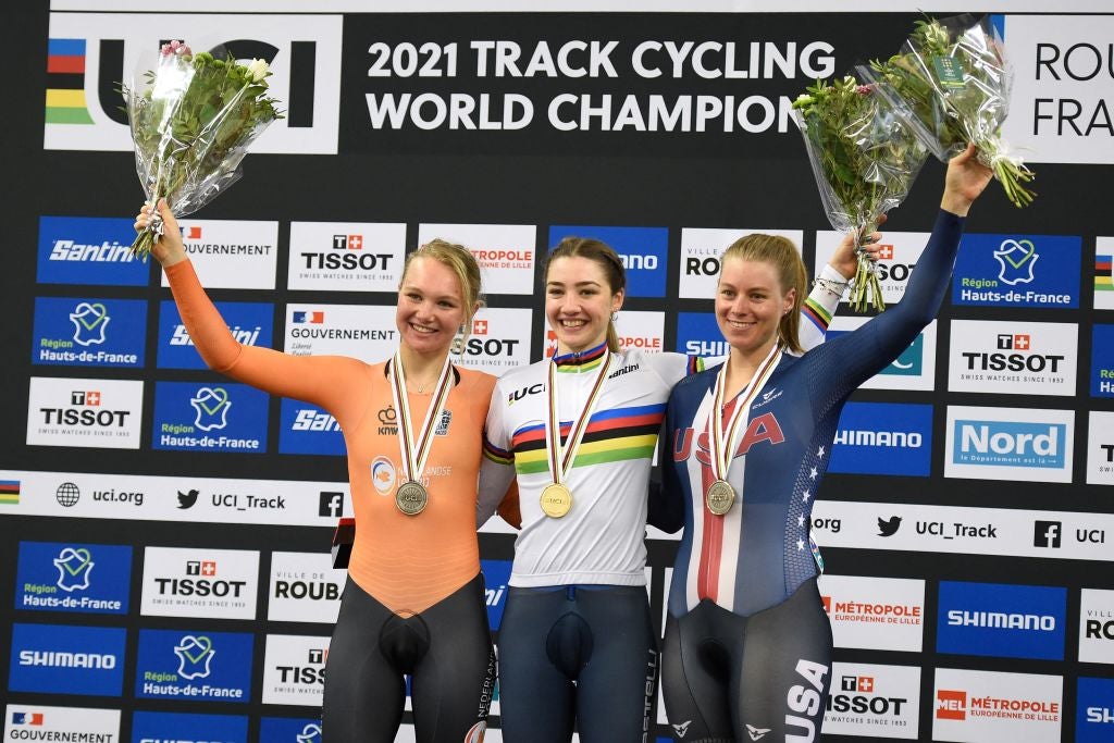 Italy's Martina Fidanza (C) poses with her gold medal past silver medallist Netherlands' Maike van der Duin (L) and bronze medallist USA's Jennifer Valente during the podium ceremony of the women's Scratch Race during the UCI Track Cycling World Championships at Jean-Stablinski velodrome in Roubaix, northern France, on October 20, 2021. (Photo by FRANCOIS LO PRESTI / AFP) (Photo by FRANCOIS LO PRESTI/AFP via Getty Images)