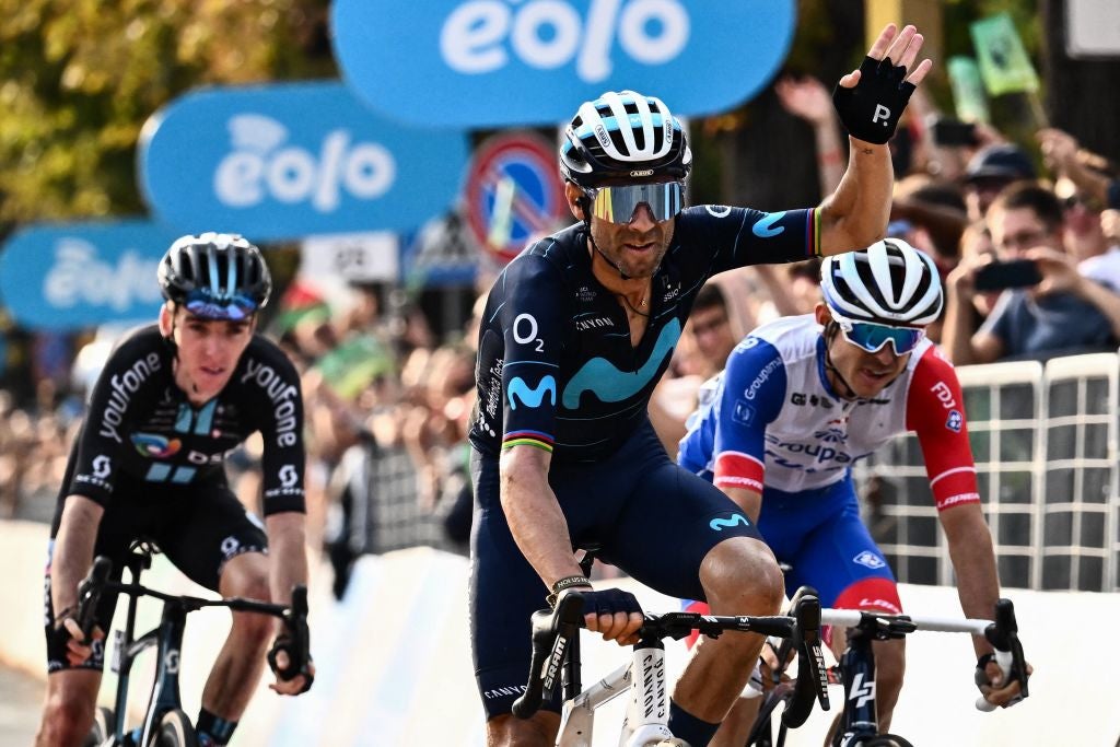 Team Movistar's rider Spain's Alejandro Valverde (C) and Team DSM team's French rider Romain Bardet (L) cross the finish line of the 116th edition of the Giro di Lombardia (Tour of Lombardy), a 252,42 km cycling race from Bergamo to Como, in Como on October 8, 2022. (Photo by Marco BERTORELLO / AFP) (Photo by MARCO BERTORELLO/AFP via Getty Images)