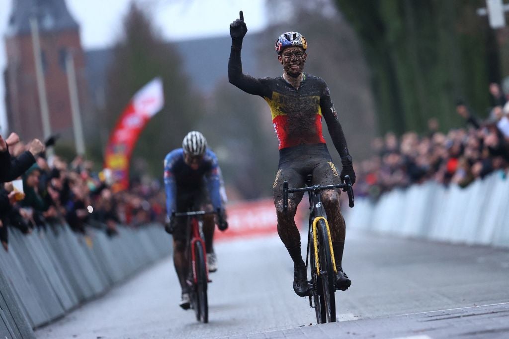 TOPSHOT - Belgian Wout Van Aert celebrates as he crosses the finish line at the end of the men's elite race of the cyclocross cycling event, race 6/8 during the 'Exact Cross' competition, on December 30, 2022 in Loenhout, Belgium. - Belgium OUT (Photo by DAVID PINTENS / BELGA / AFP) / Belgium OUT (Photo by DAVID PINTENS/BELGA/AFP via Getty Images)