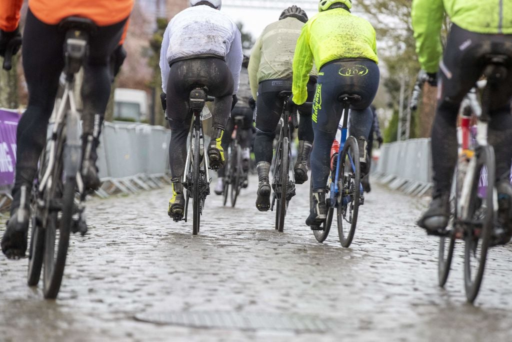 Fans raced in wet conditions Saturday and more rain is expected Sunday for Tour of Flanders.