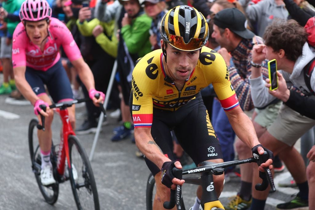 Spectators cheer as Jumbo-Visma's Slovenian rider Primoz Roglic and overall leader INEOS Grenadiers's British rider Geraint Thomas (Rear L) cycle in the last kilometers of the final ascent, during the nineteenth stage of the Giro d'Italia 2023 cycling race, 183 km between Longarone and Tre Cime di Lavaredo (rifugio Auronzo) on May 26, 2023. (Photo by Luca Bettini / AFP) (Photo by LUCA BETTINI/AFP via Getty Images)
