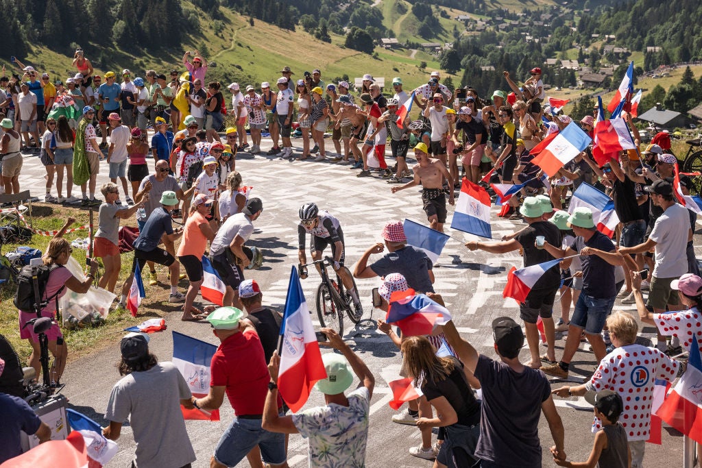 SAINT-GERVAIS MONT-BLANC, FRANCE - JULY 16: Marc Soler of Spain and UAE Team Emirates competes in the breakaway climbing to the Col des Aravis (1483m) while fans cheer during the stage fifteen of the 110th Tour de France 2023 a 179km stage from Les Gets les Portes du Soleil to Saint-Gervais Mont-Blanc 1379m / #UCIWT / on July 16, 2023 in Saint-Gervais Mont-Blanc, France. (Photo by David Ramos/Getty Images)
