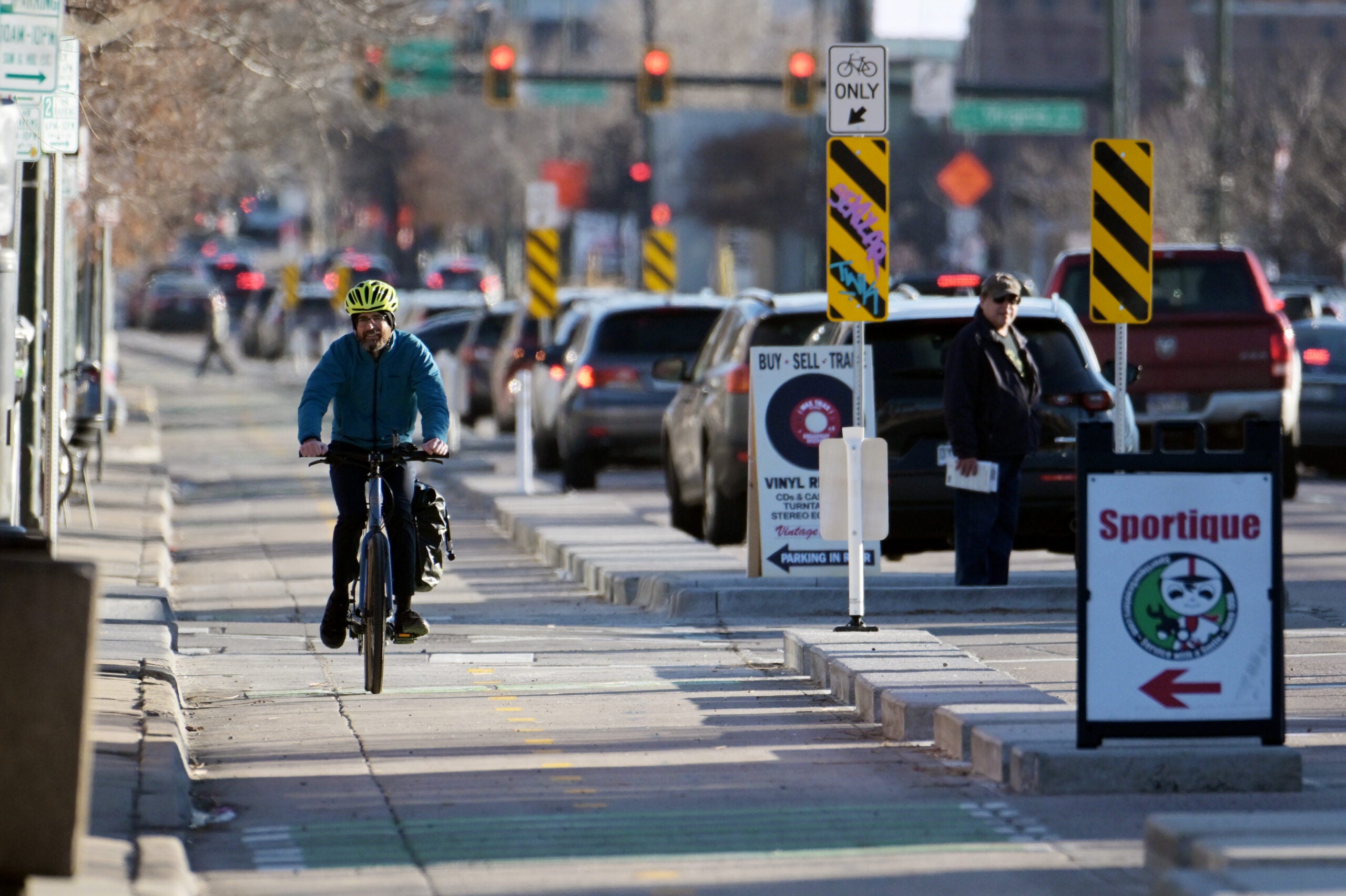 Cyclist-on-road-in-Denver-Colorado-Broadway-Bike-Lane-Urbanist-Update-scaled